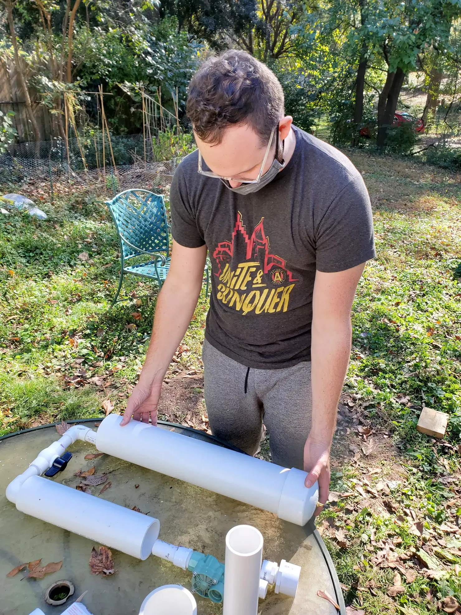 Man assembling PVC pipe to test for size and fit